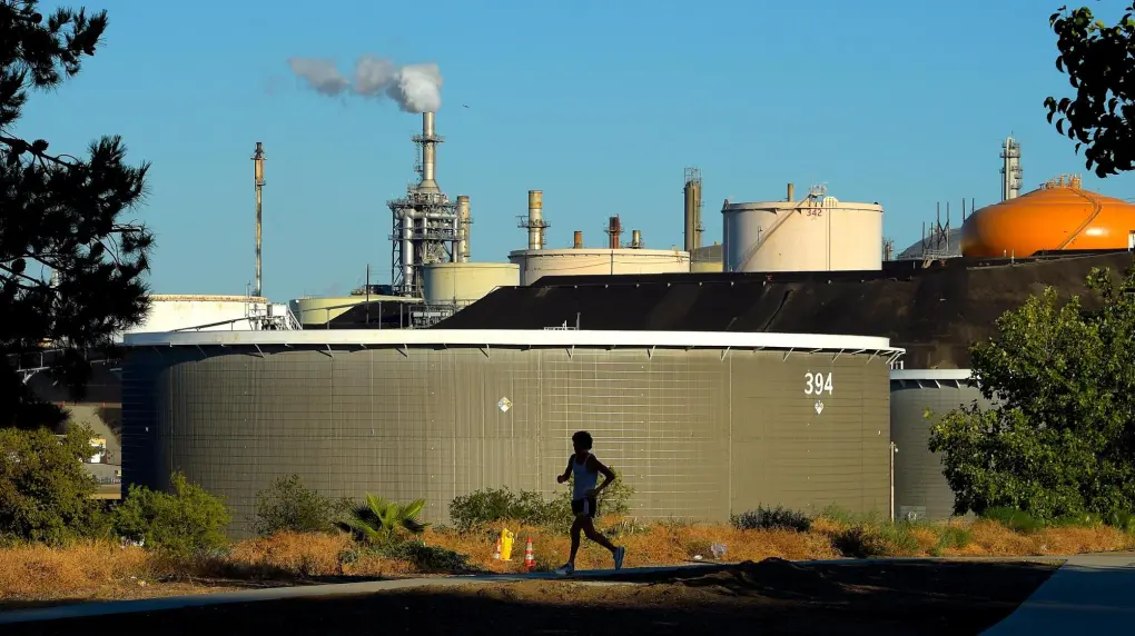 A person running alongside a factory