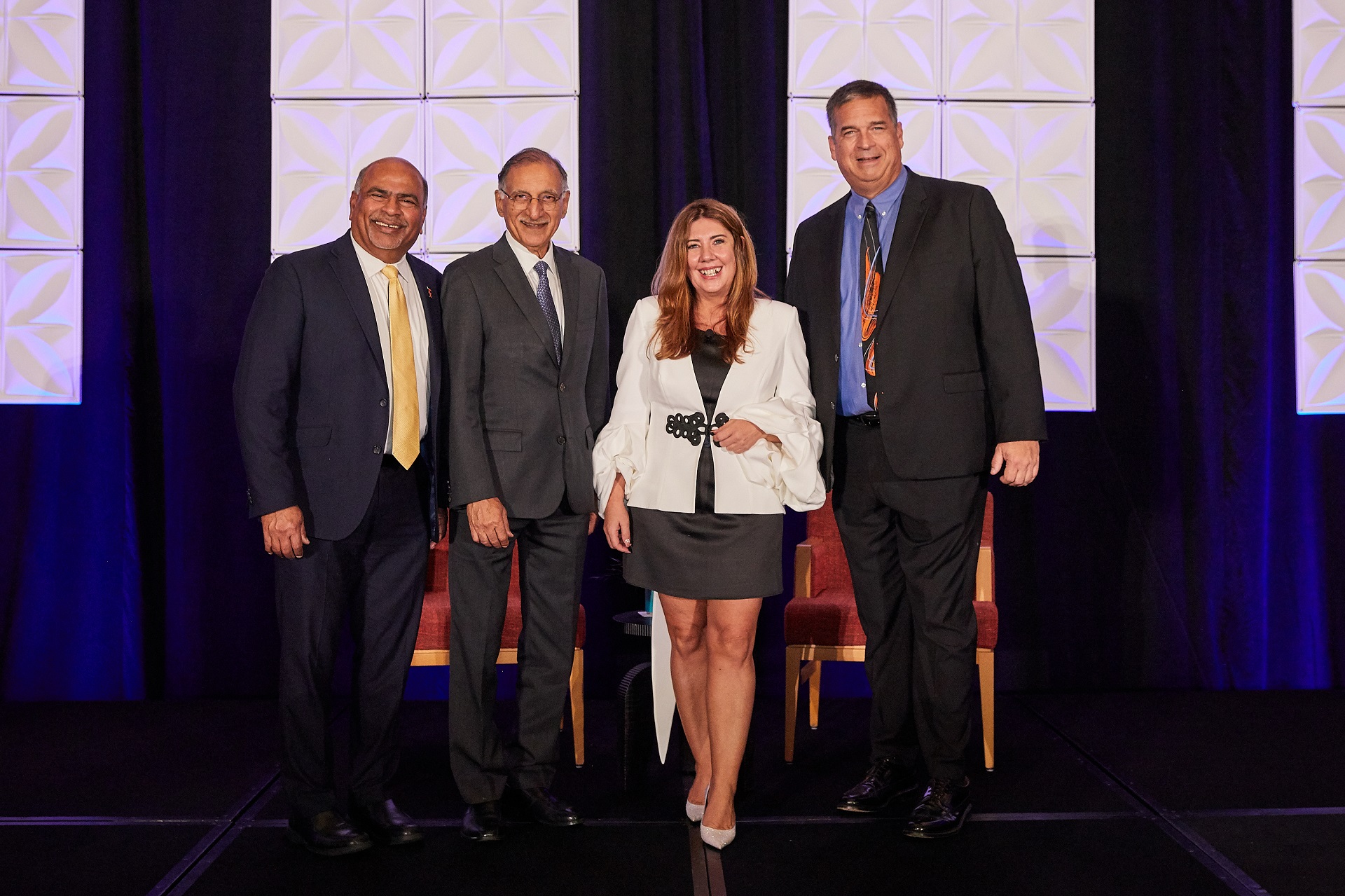 From left to right: Sri Sundaram, Dean of the College of Business and Economics at CSUF; Dr. Anil K. Puri, Provost Emeritus and Director of the Woods Center for Economic Analysis and Forecasting at CSUF; Dr. Mira Farka, Professor of Economics and Co-Director of the Woods Center for Economic Analysis and Forecasting at CSUF; and Jeff Ball, President and CEO of Orange County Business Council.