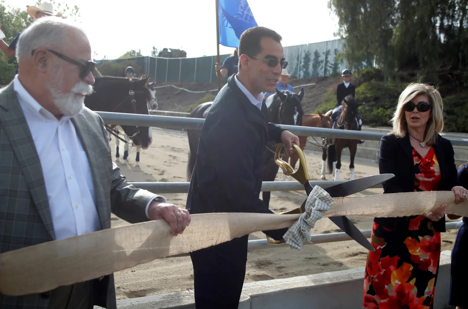 Mayor Carlos Rodriguez, center, with mayor pro tem Gene Hernandez, left, and councilwoman Beth Haney, as the mayor cuts the ribbon during a ceremony and horse riding demonstration to commemorate the recent facility improvements to the Phillip S. Paxton Equestrian Center in Yorba Linda, on Tuesday, March 15, 2022. (Photo by Alex Gallardo, Contributing Photographer)